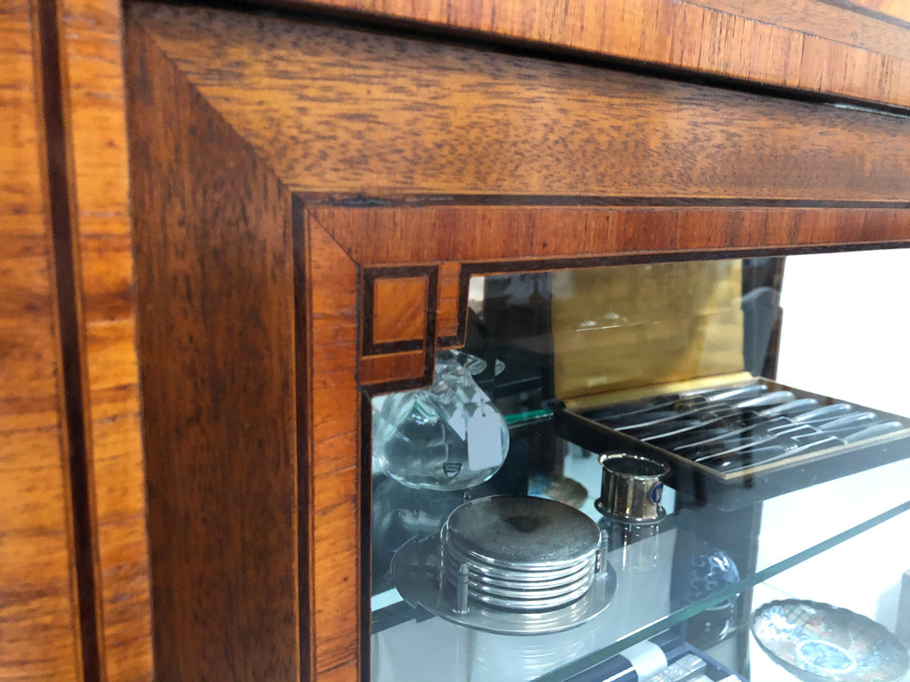 Beautiful French walnut and parquetry inlaid vitrine with lovely bevelled glass and a marble top. It comes with four glass shelves which are adjustable and it is in good original condition.