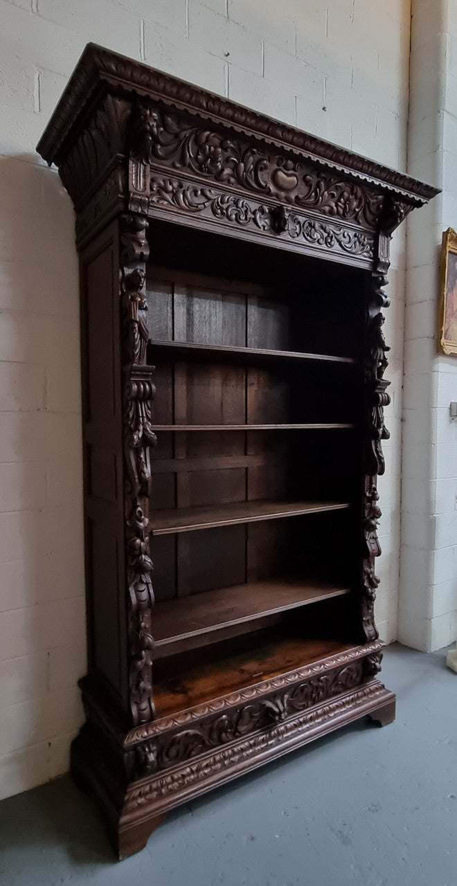 Amazing dark Oak heavily carved Gothic style bookcase with lovely details and adjustable shelves in good original detailed condition. The doors currently have no glass which can easily be added or be left with open shelves.