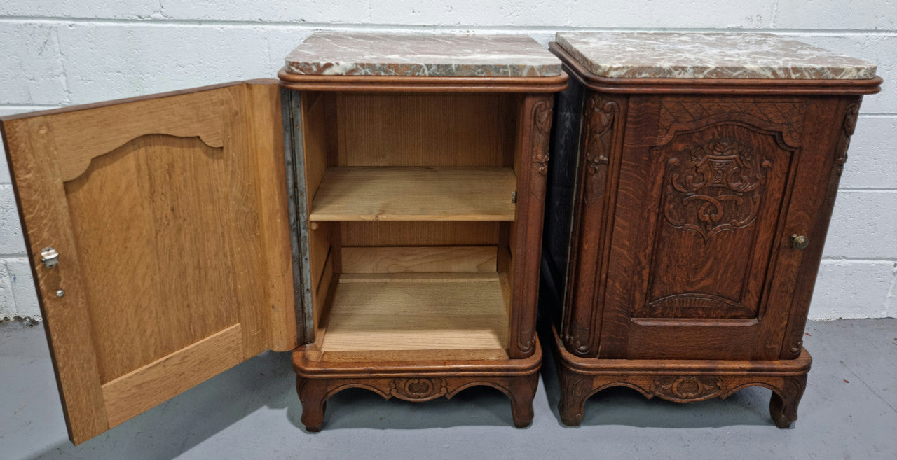 Lovely pair of French oak bedside cabinets with nicely carved details and marble tops. In good original detailed condition.