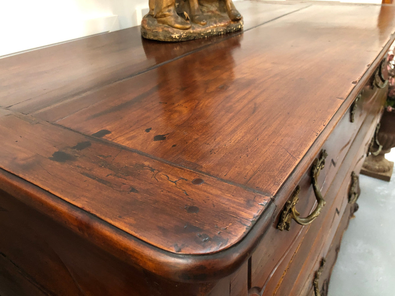 Beautiful 18th Century French all Cherrywood three drawer commode with beautiful ormolu mounts and handles. It is in good original detailed condition.