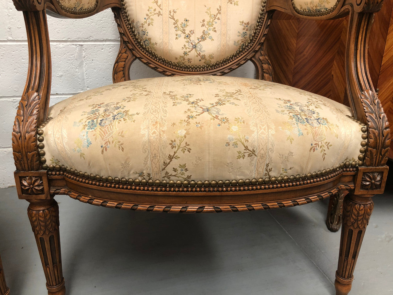 Pair of Antique French Louis XVI style carved Walnut fauteuils in restored condition. The Tapestry upholstery is in good condition some marks and wear but usable.