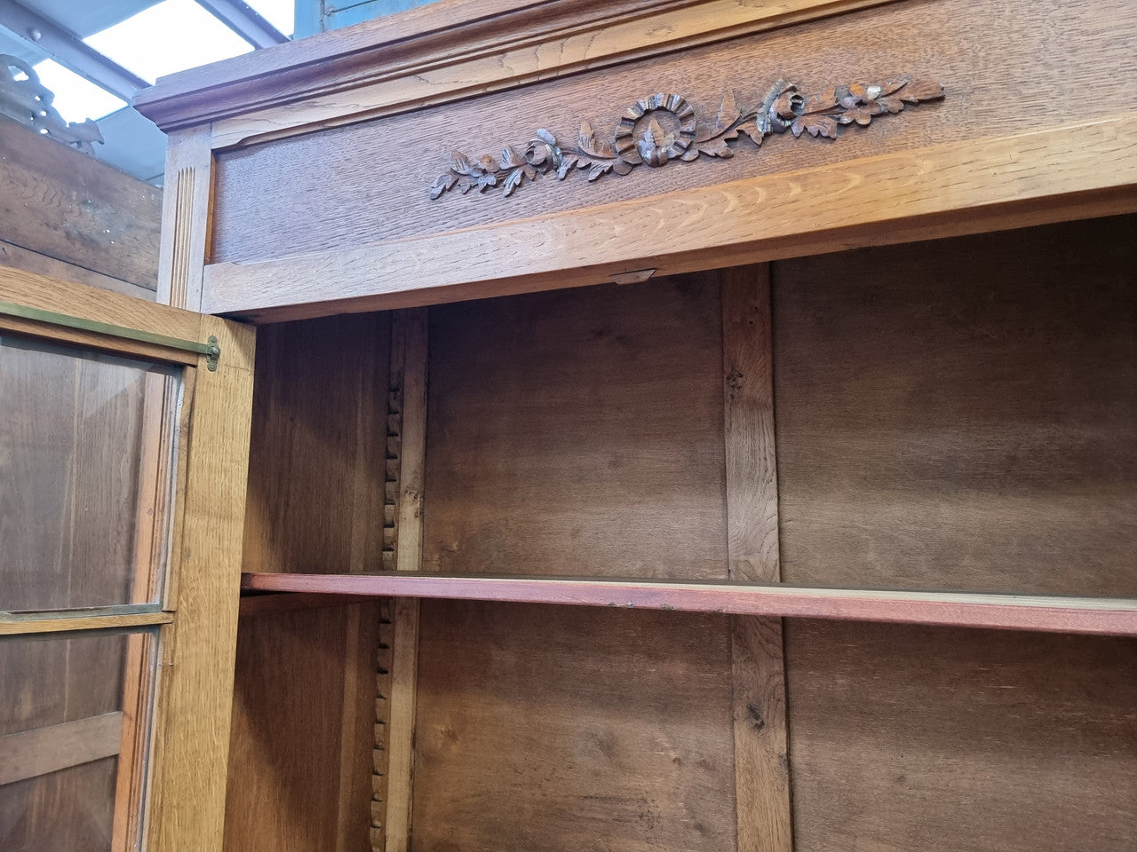 French light Oak two door bookcase with four adjustable shelves. It has beautiful decorative carving and is in good original detailed condition.