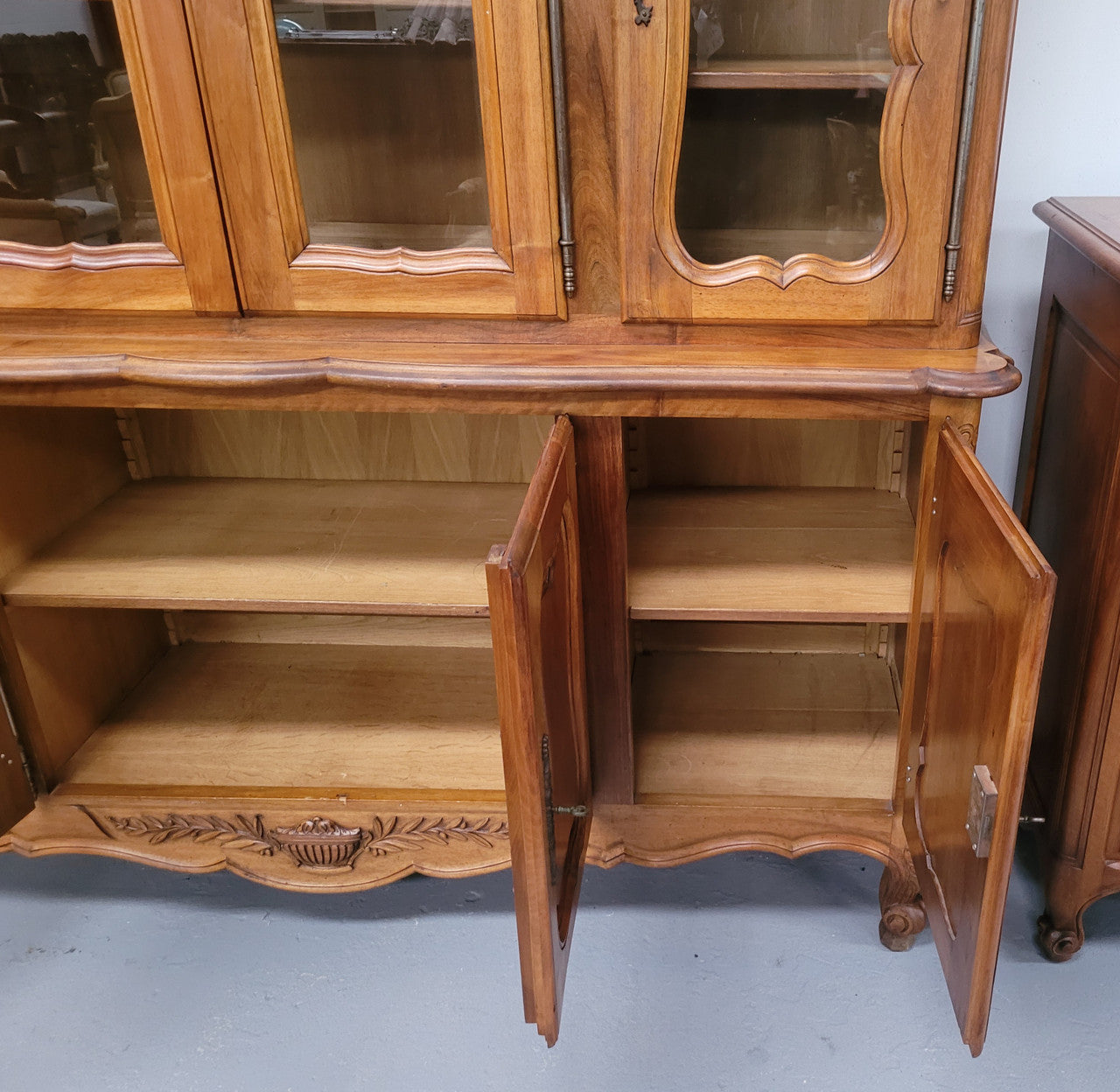 Magnificent French Walnut two-body four door display cabinet. Heaps of storage space with four glass doors at the top with shelves and four solid doors below also with shelving. It has been sourced from France and comes with a key for each door and all are lockable. In good original detailed condition.