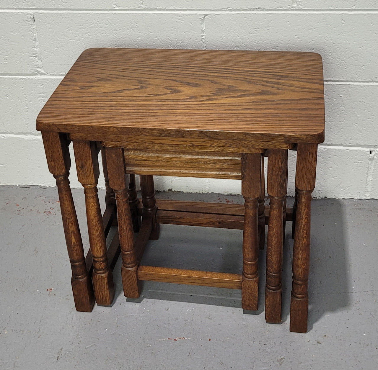 Lovely tudor oak style three nest tables. Circa 1950, In good original detailed condition.