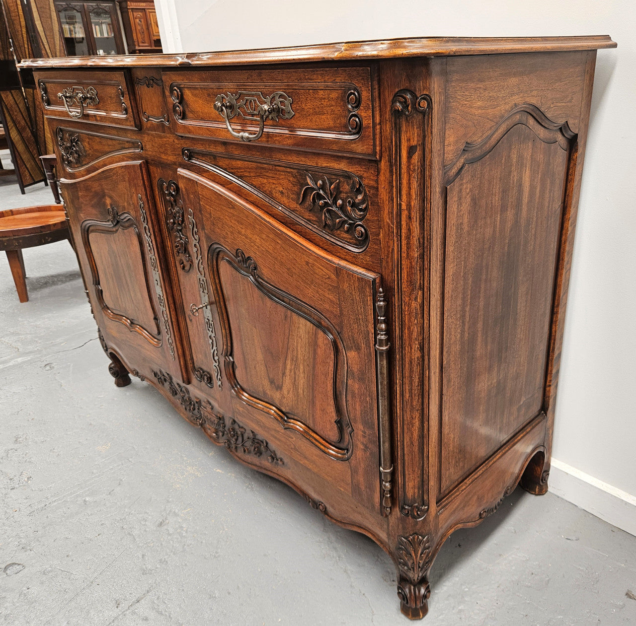 Attractive French Walnut Louis XV style two door two drawer sideboard featuring beautiful carving. Circa: 1930's. It has been sourced from France and it is in good original detailed condition.