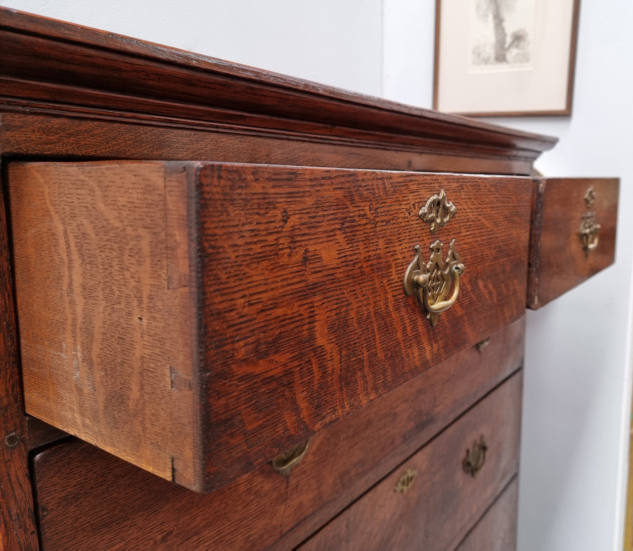 Early 19th Century English Oak chest on stand. It has been sourced in France and has plenty of storage space with eight drawers. In good original detailed condition.