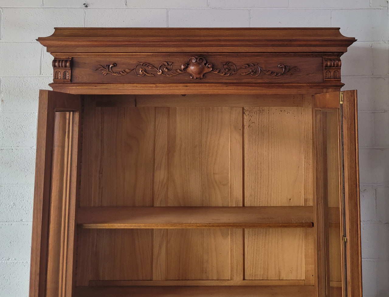 Stunning French Walnut Henry II style two door bookcase with four fully adjustable shelves. The lock on the door is functional and has a key. It is in good original detailed condition.