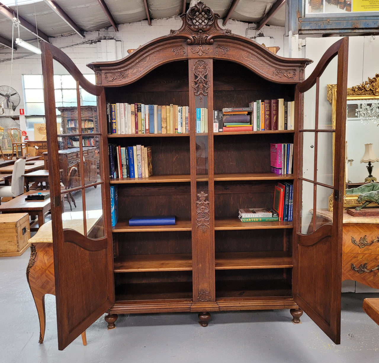 Substantial French Oak Louis 15th Style large two door bookcase. Adjustable shelves and very decorative carving. In good original detailed condition.