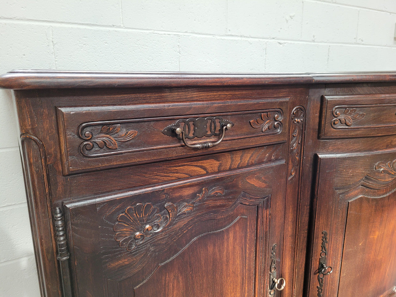 French dark oak three door and three drawer sideboard. Plenty of storage space and it is in good original detailed condition.