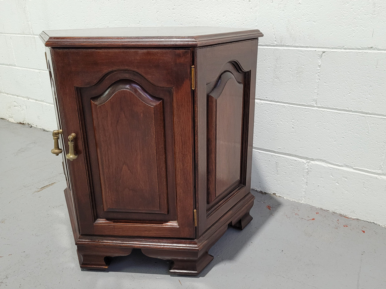 Hexagonal Mahogany enclosed side cabinet with two doors. Would make an ideal side cabinet and is in good restored condition.