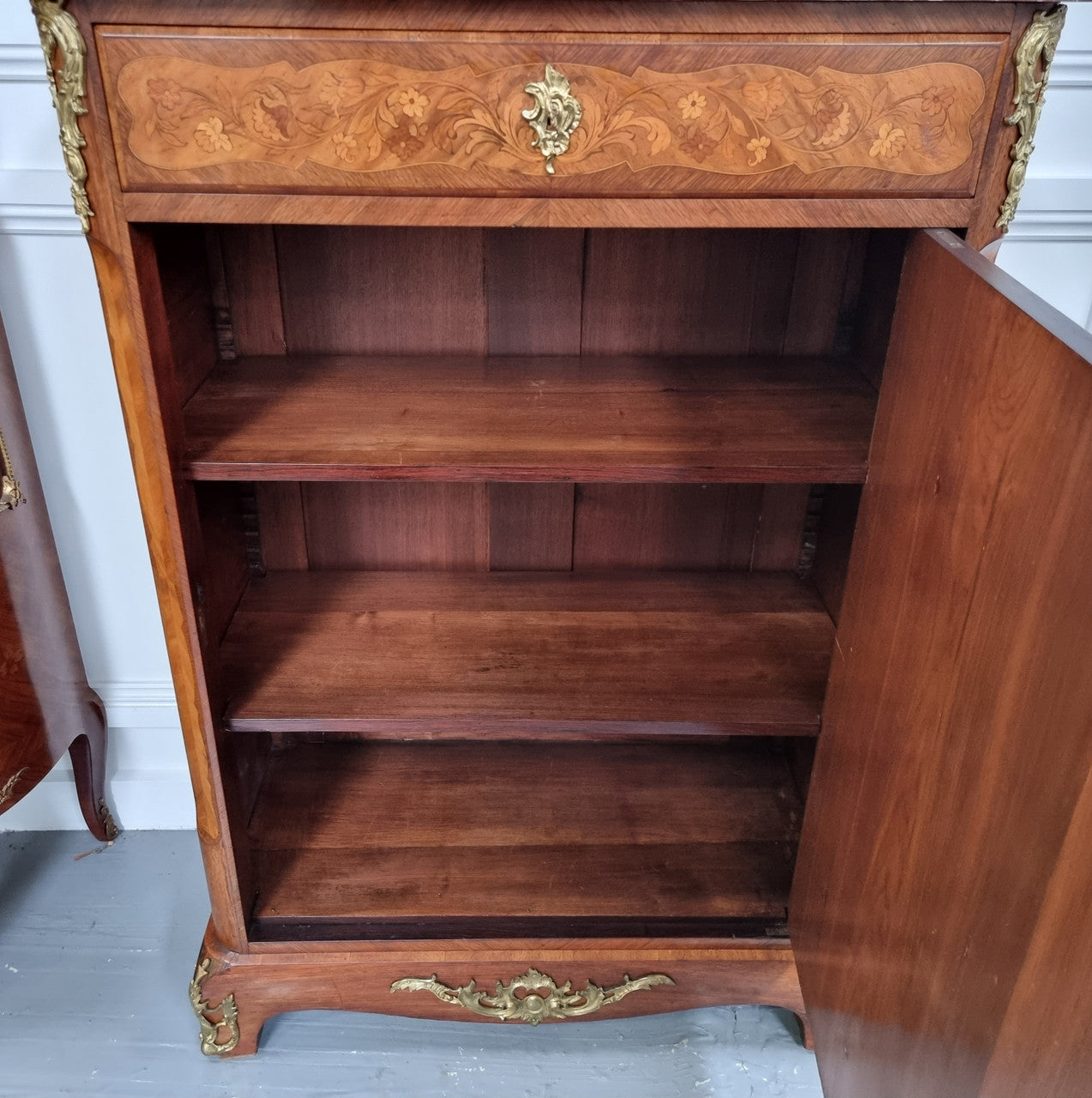 Elegant French transitional style Walnut & Kingwood Salon cabinet. It has beautiful marquetry inlay, a marble top and decorative ormolu mounts. Sourced From France and is in good original detailed condition.