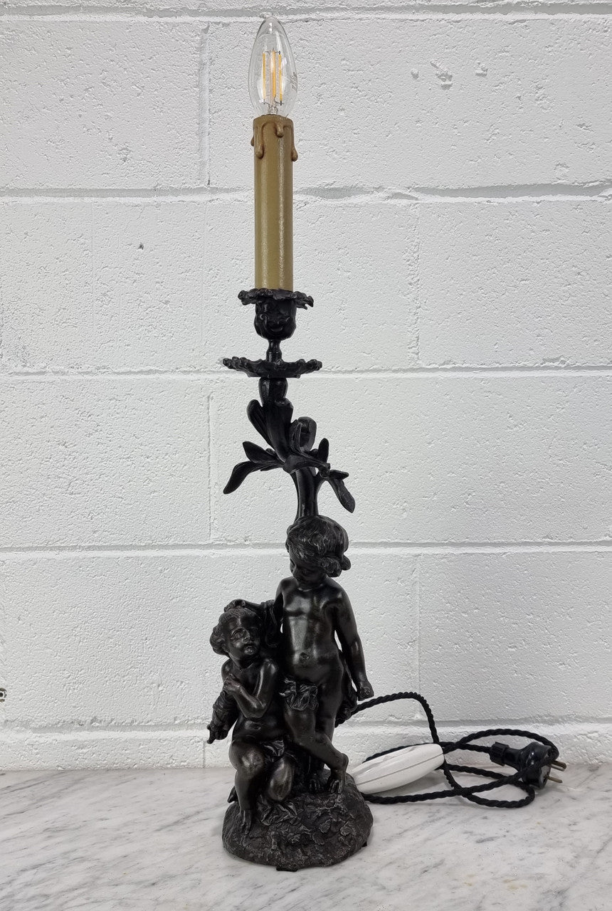 Antique French bronzed metal lamp with cherub's. in very good working original detailed condition.