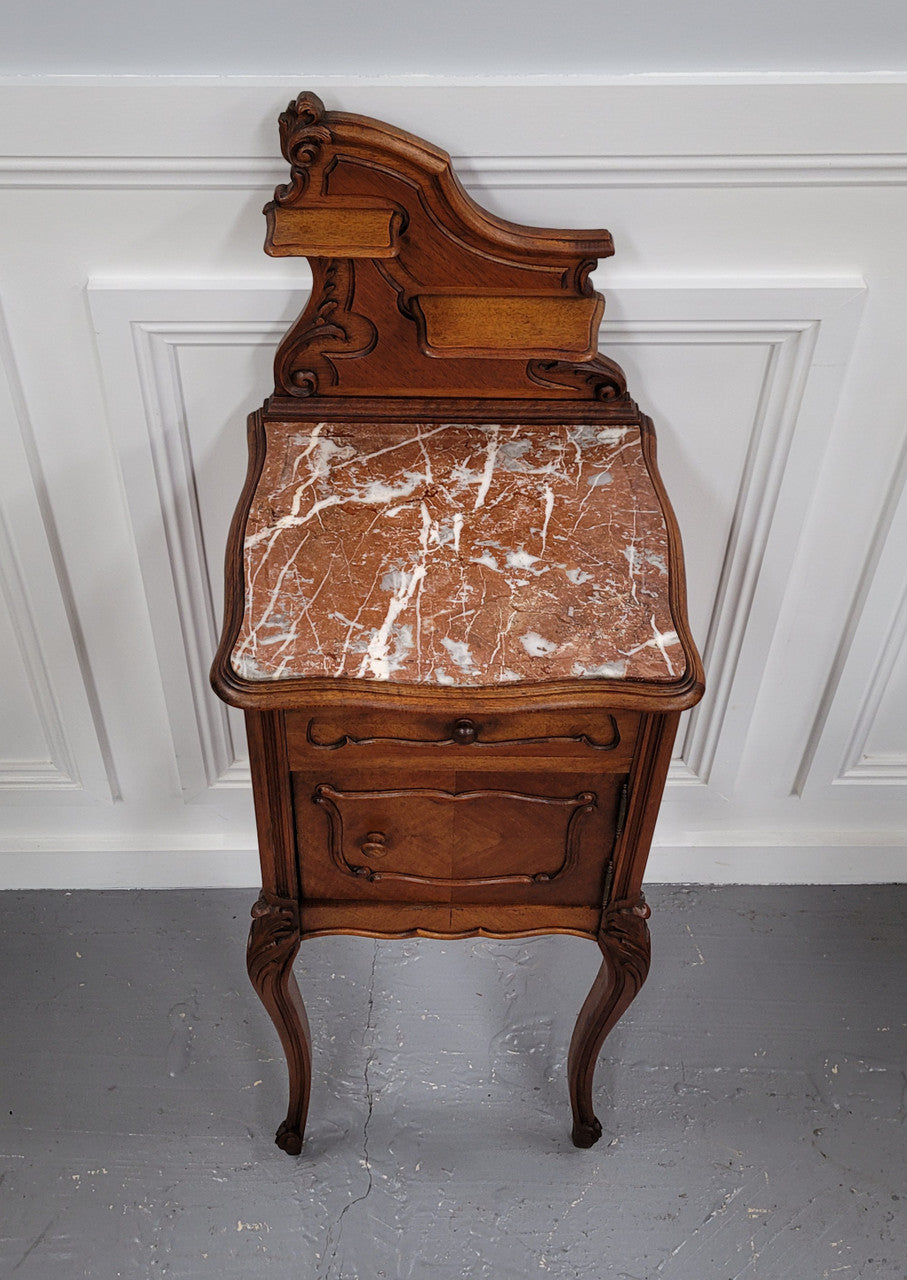 French Louis XV style Walnut single bedside cupboard with inset marble top. It has been sourced from France and is in good original detailed condition.