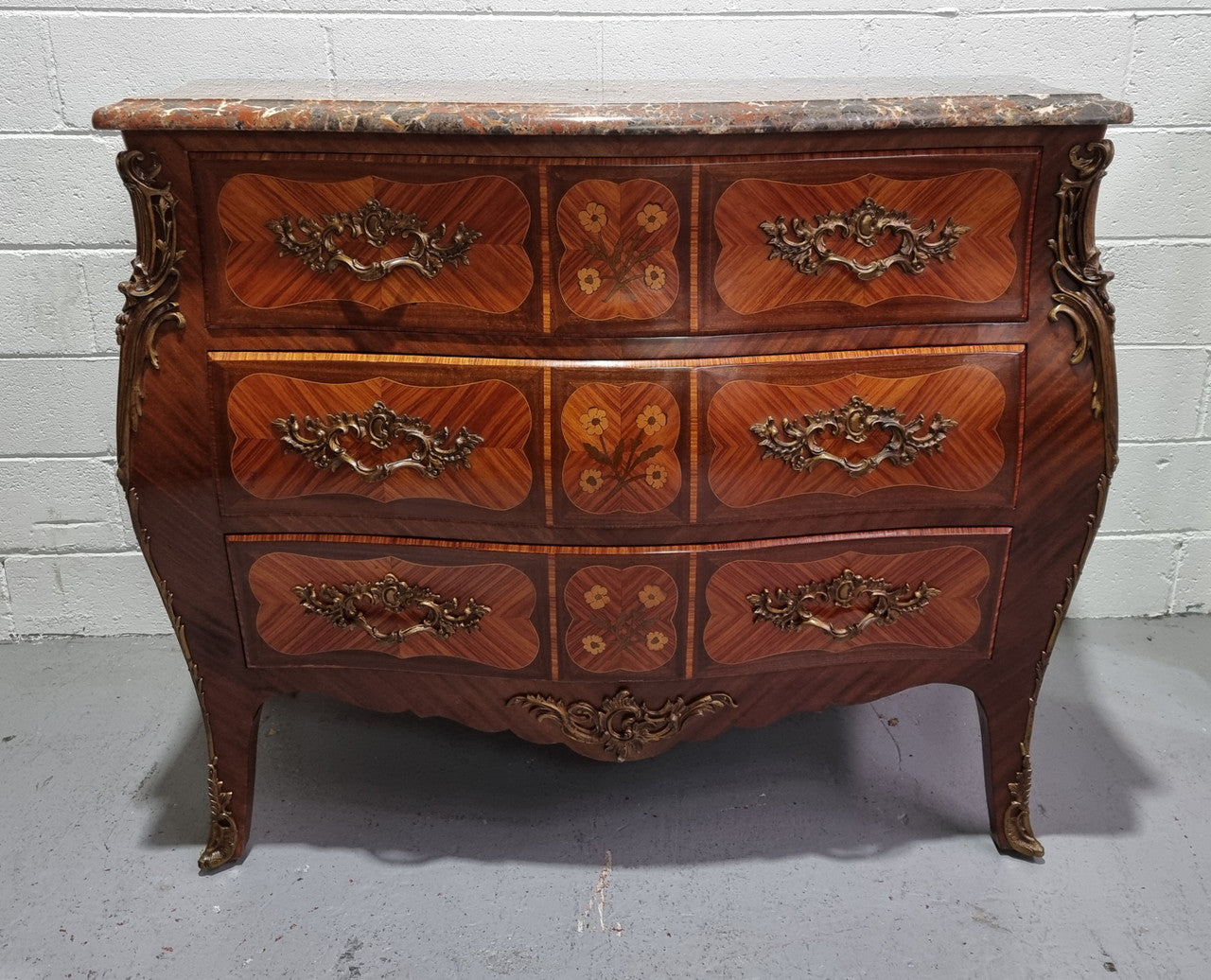 French Walnut and Kingwood Louis XV style marquetry inlaid commode with three drawers and a beautiful marble top. It is in good original detailed condition.