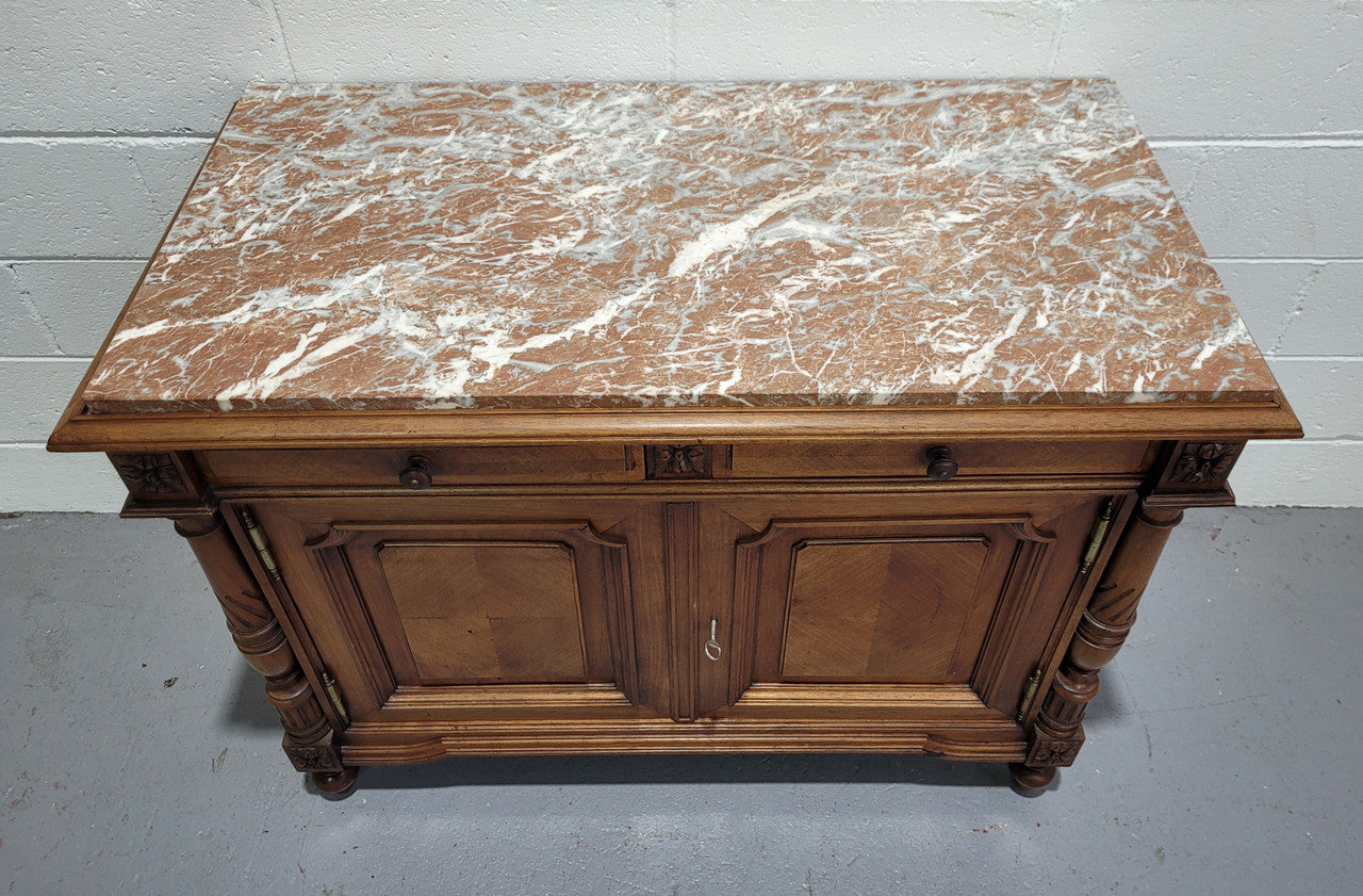 Stunning French walnut Henry II style marble top side cabinet with two drawers and two shelves inside. In good original detailed condition.