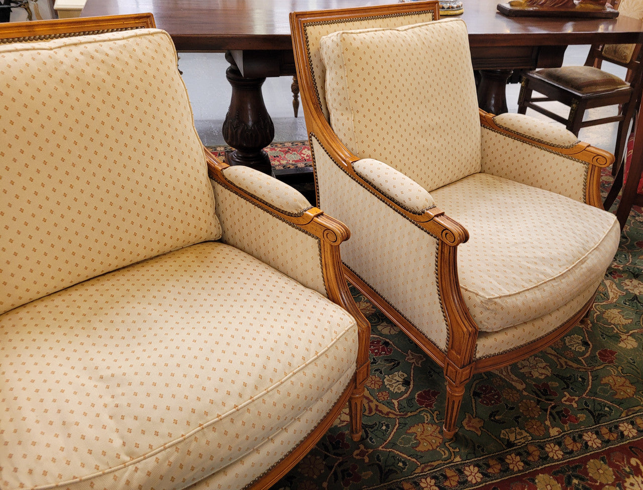 Pair of Louis XVI style 19th Century walnut upholstered Bergère chairs with loose cushions. They have been sourced from France and is in good original detailed condition. The fabric is in good original used condition, please view photos as they help form part of the description.