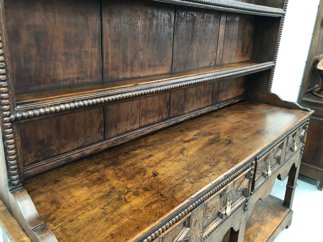 Fabulous Antique Tudor style Oak kitchen dresser with two drawers and two shelves. It is in good original detailed condition.