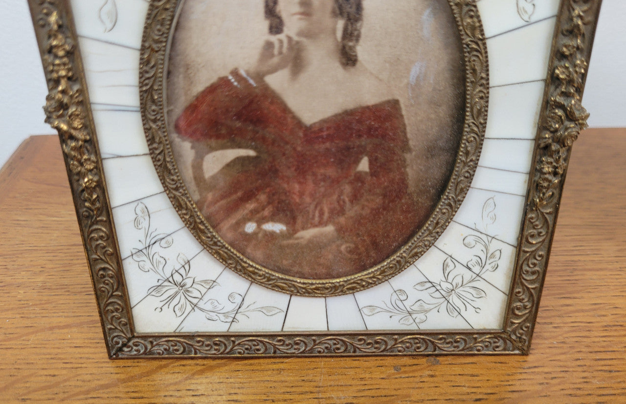 Hand coloured early photo of women in a stunning frame with paino key surround and detailed gilded metal frame.