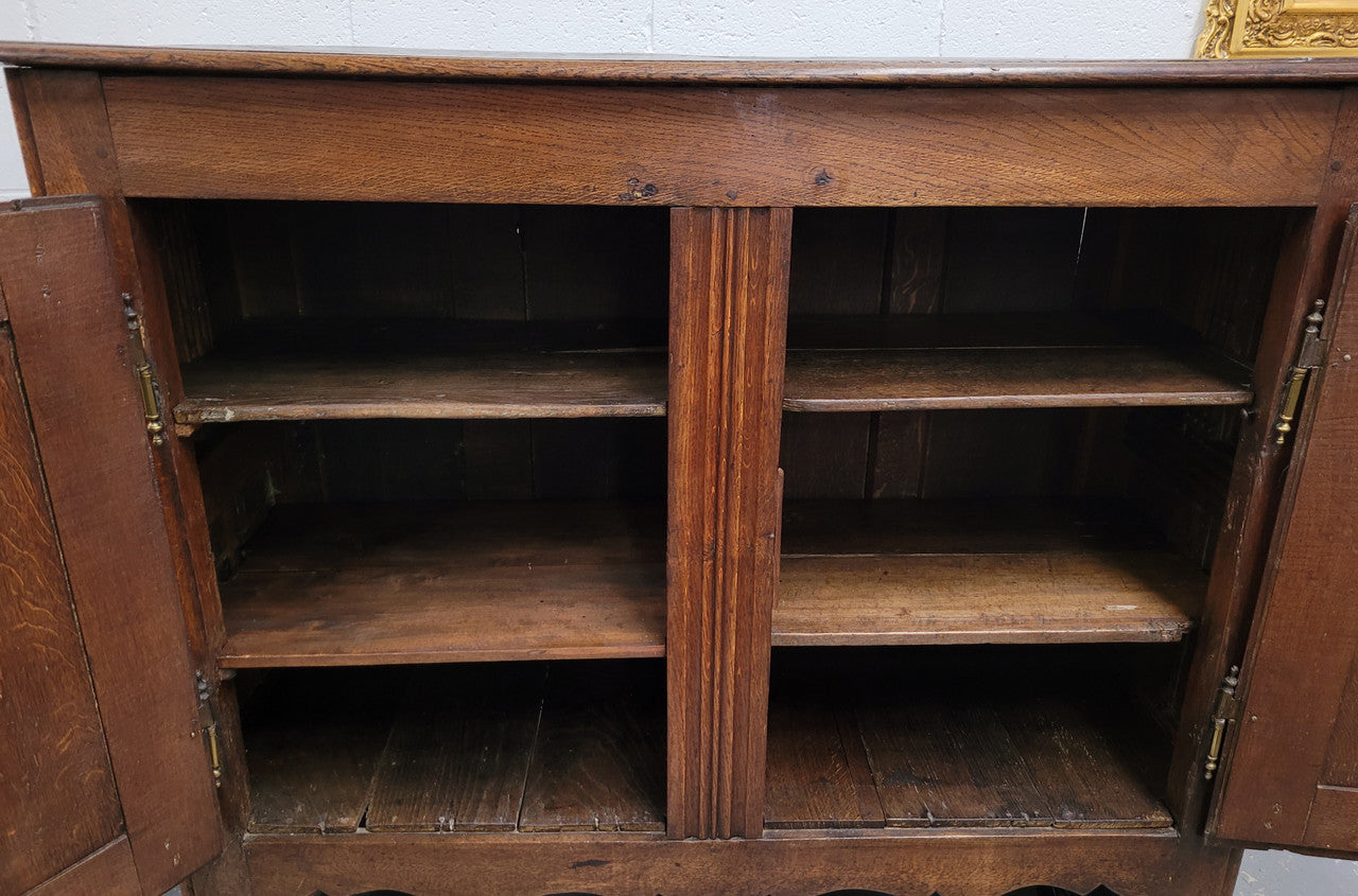 A charming French Oak early 18th Century two door sideboard. Plenty of storage space with two fixed shelves either side. It is in good original detailed condition for its age and comes with a working key and working locks.