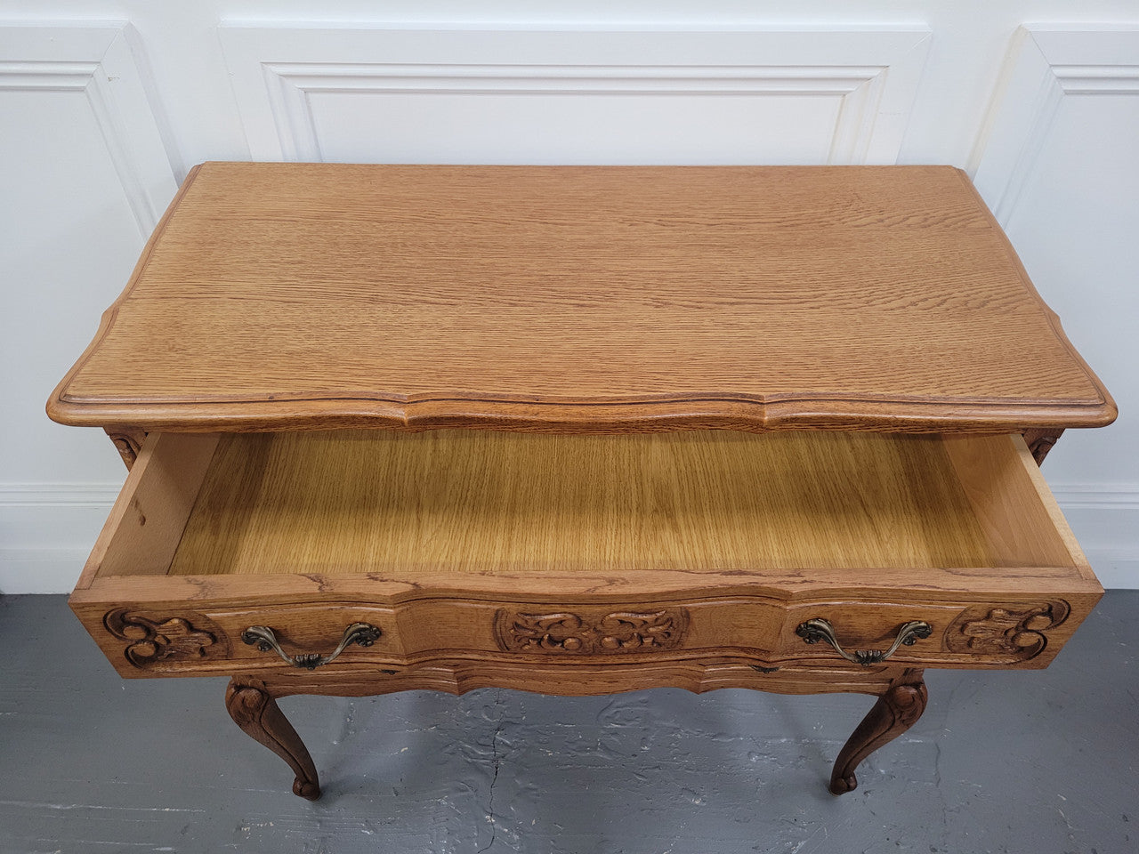 French Oak Louis 15th style nicely carved three drawer wooden top commode. It has been sourced from France and is in good original detailed condition.