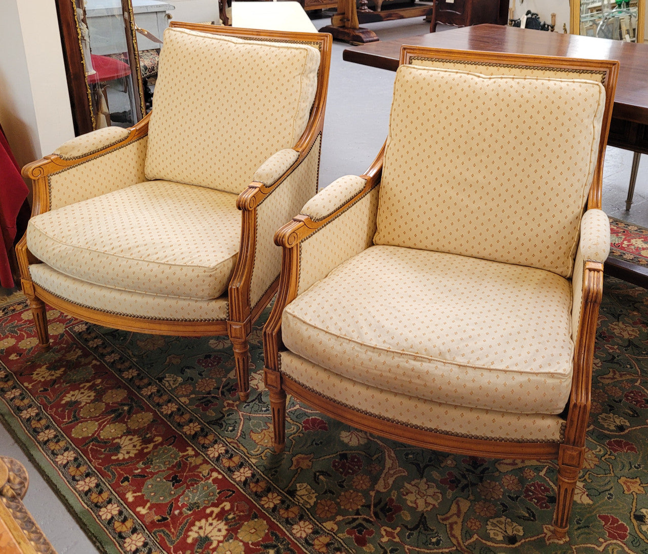 Pair of Louis XVI style 19th Century walnut upholstered Bergère chairs with loose cushions. They have been sourced from France and is in good original detailed condition. The fabric is in good original used condition, please view photos as they help form part of the description.