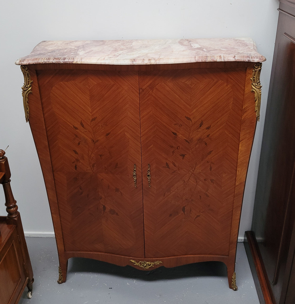 French Louis 15th style Kingwood marquetry inlaid two door cupboard with a beautiful marble top. It has three adjustable shelves and decorative ormolu trim. It has been sourced from France and is in good original detailed condition.