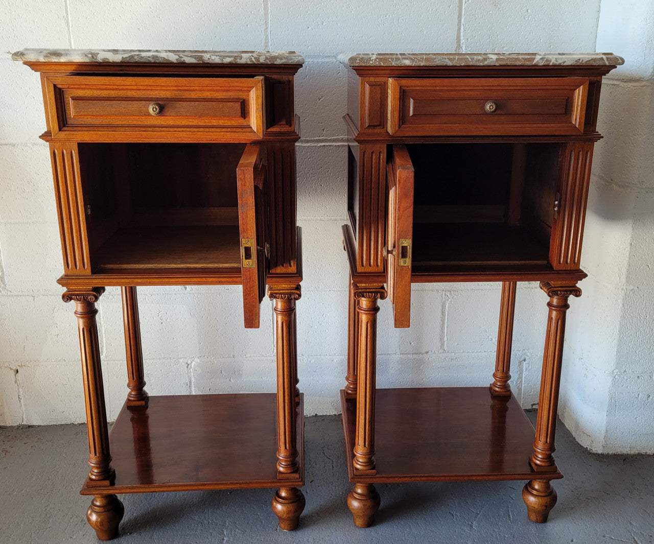 Pair of Henry II style Walnut bedside cabinets with a marble top. Circa 1920s and in good original condition.