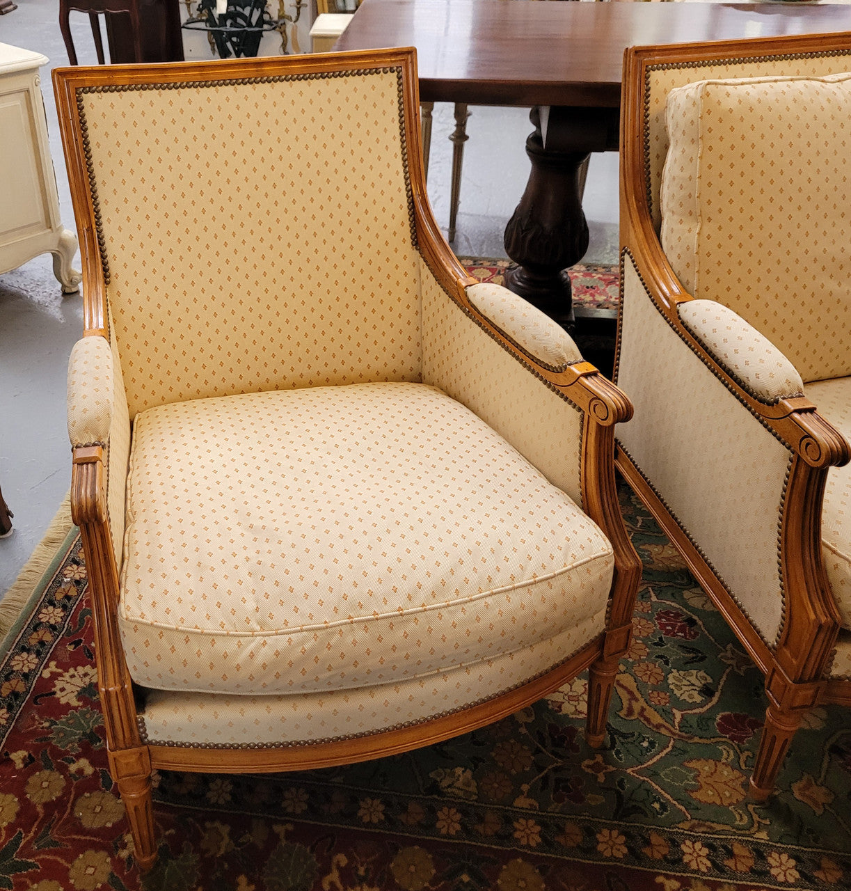 Pair of Louis XVI style 19th Century walnut upholstered Bergère chairs with loose cushions. They have been sourced from France and is in good original detailed condition. The fabric is in good original used condition, please view photos as they help form part of the description.