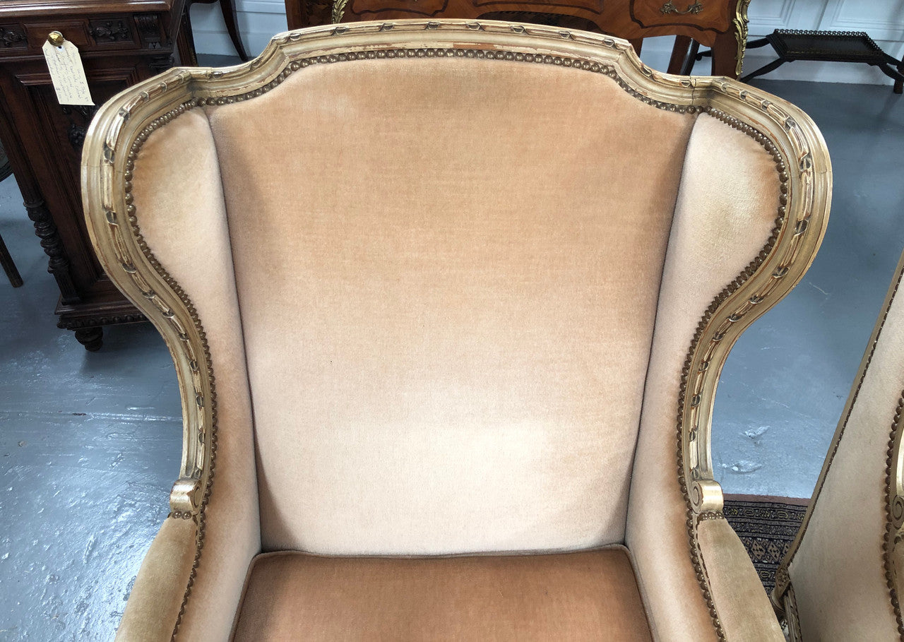 Pair of Vintage French original painted bergere wingback armchairs. The fabric is in very good original condition, please view photos as they help form part of the description. Please note the matching foot stool is being sold separately.
