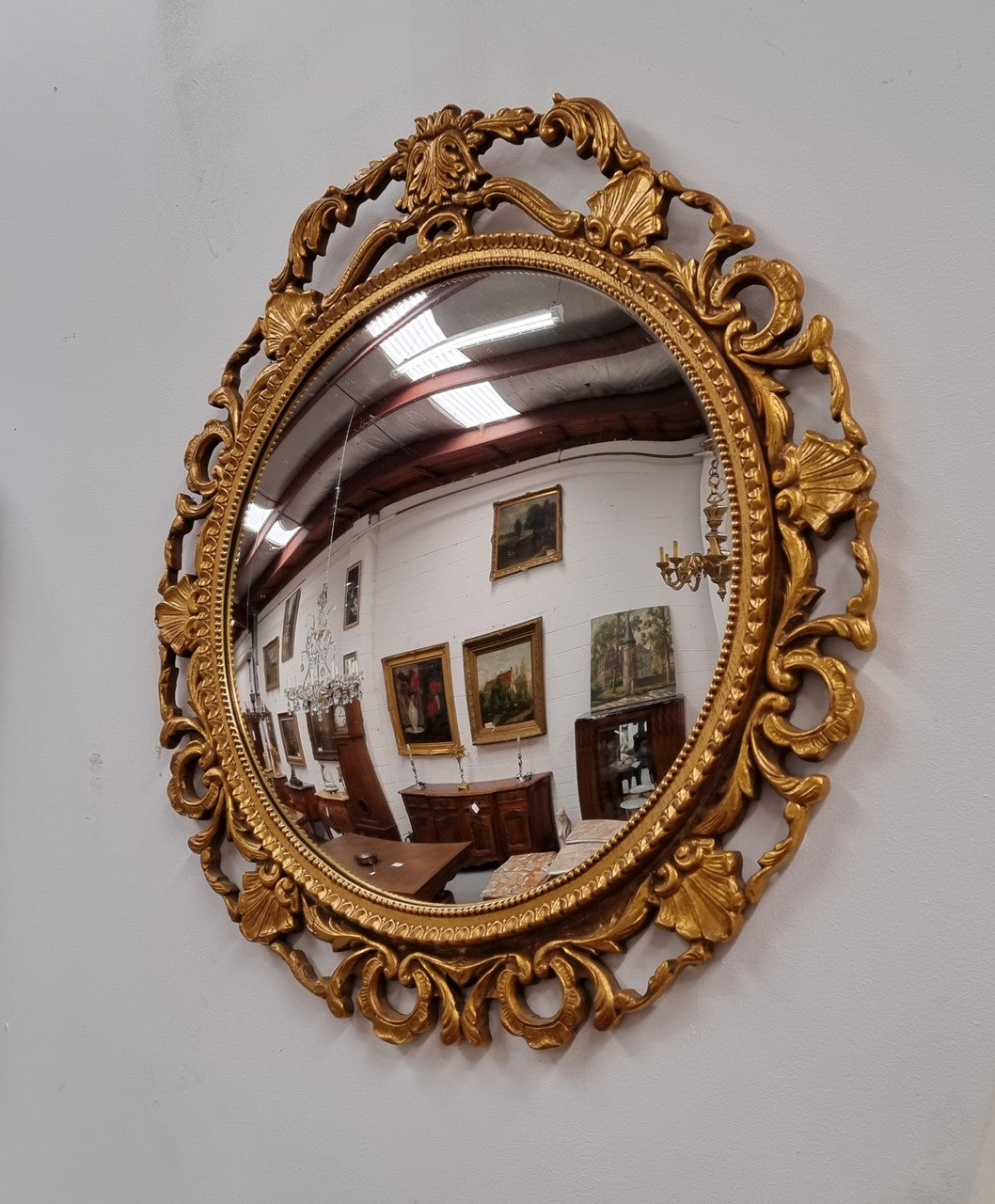 Vintage large round ornate convex mirror. Lovely gilt decoration around and is in good original condition.