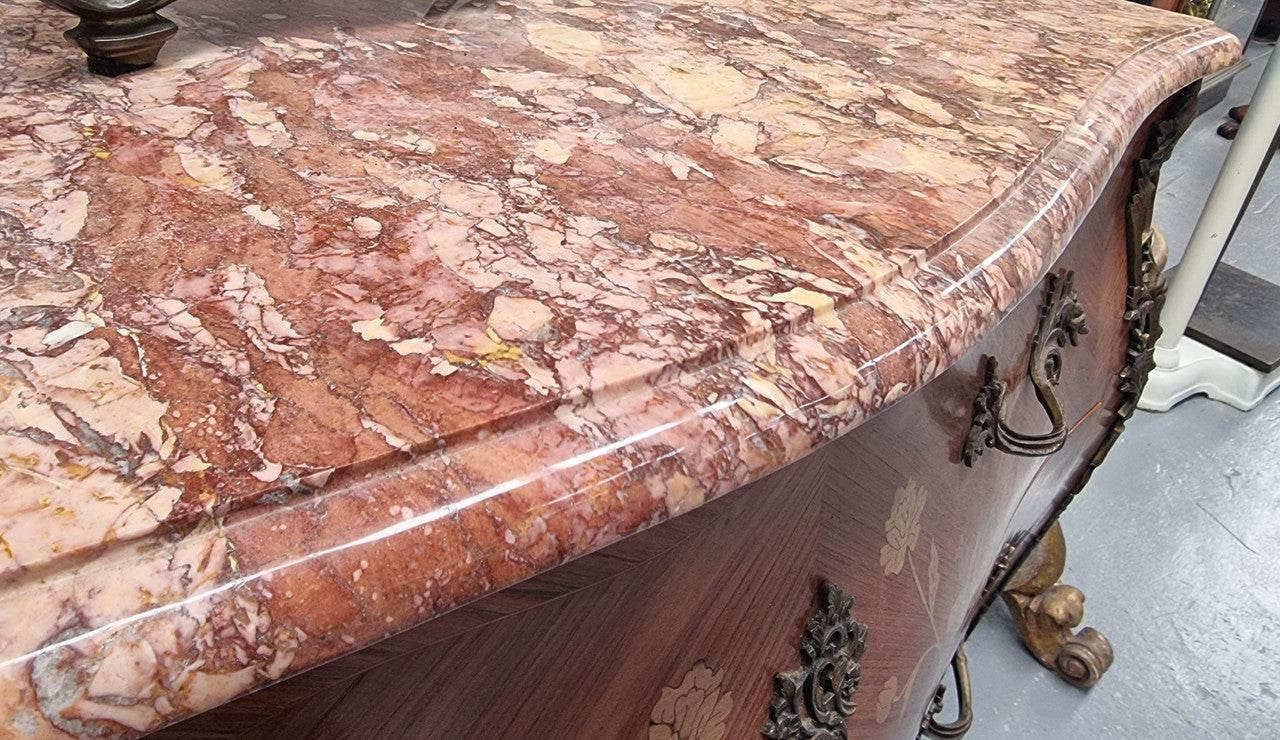 Stunning Louis XV style marquetry inlay marble top two drawer commode. It has decorative ormolu mounts and beautiful marble top. In good original detailed condition.