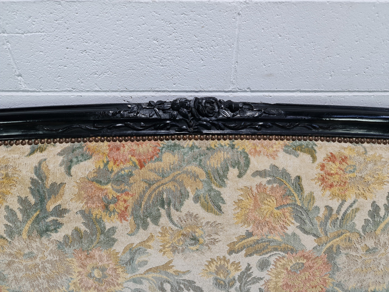 A Substantial Antique 19th Century Louis XV style ebonized serpentine front settee. The fabric is in used condition showing use and could be used as is or reupholster.