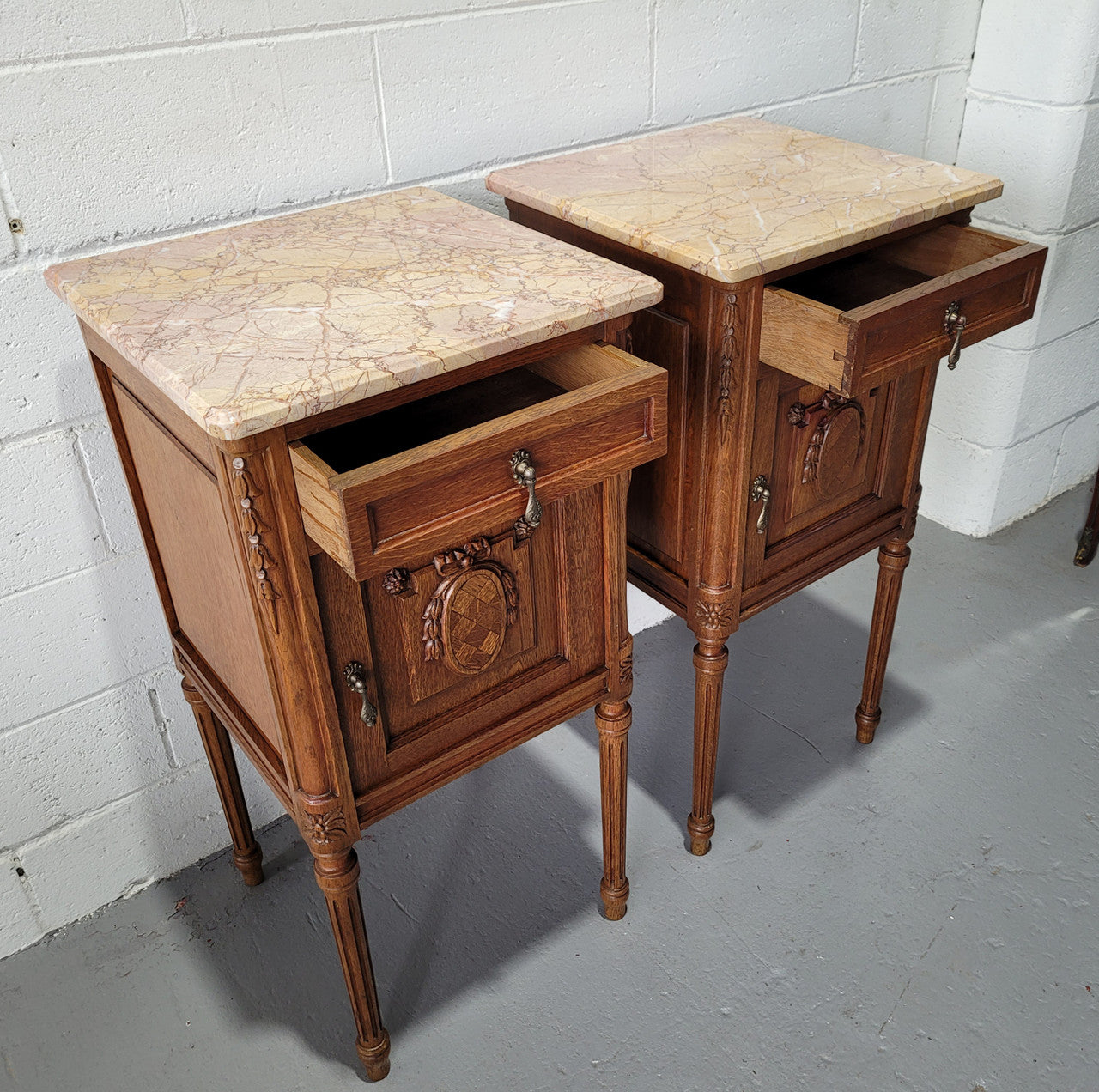 Pair of Louis XV French Oak and marble top bedside cabinets. They have beautiful detailed carving and stunning colour marble top. They are in very good original detailed condition.