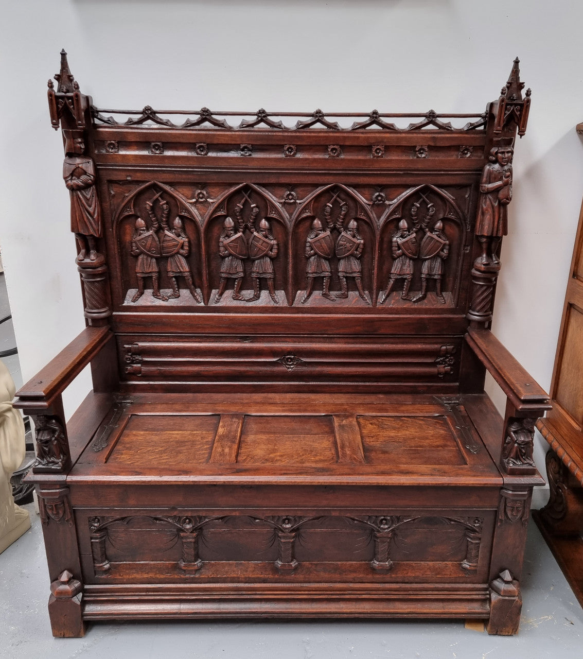 Early 19th Century French Oak Gothic style hall seat with a lift up seat. It has amazing detailed carvings and is in good original detailed condition.