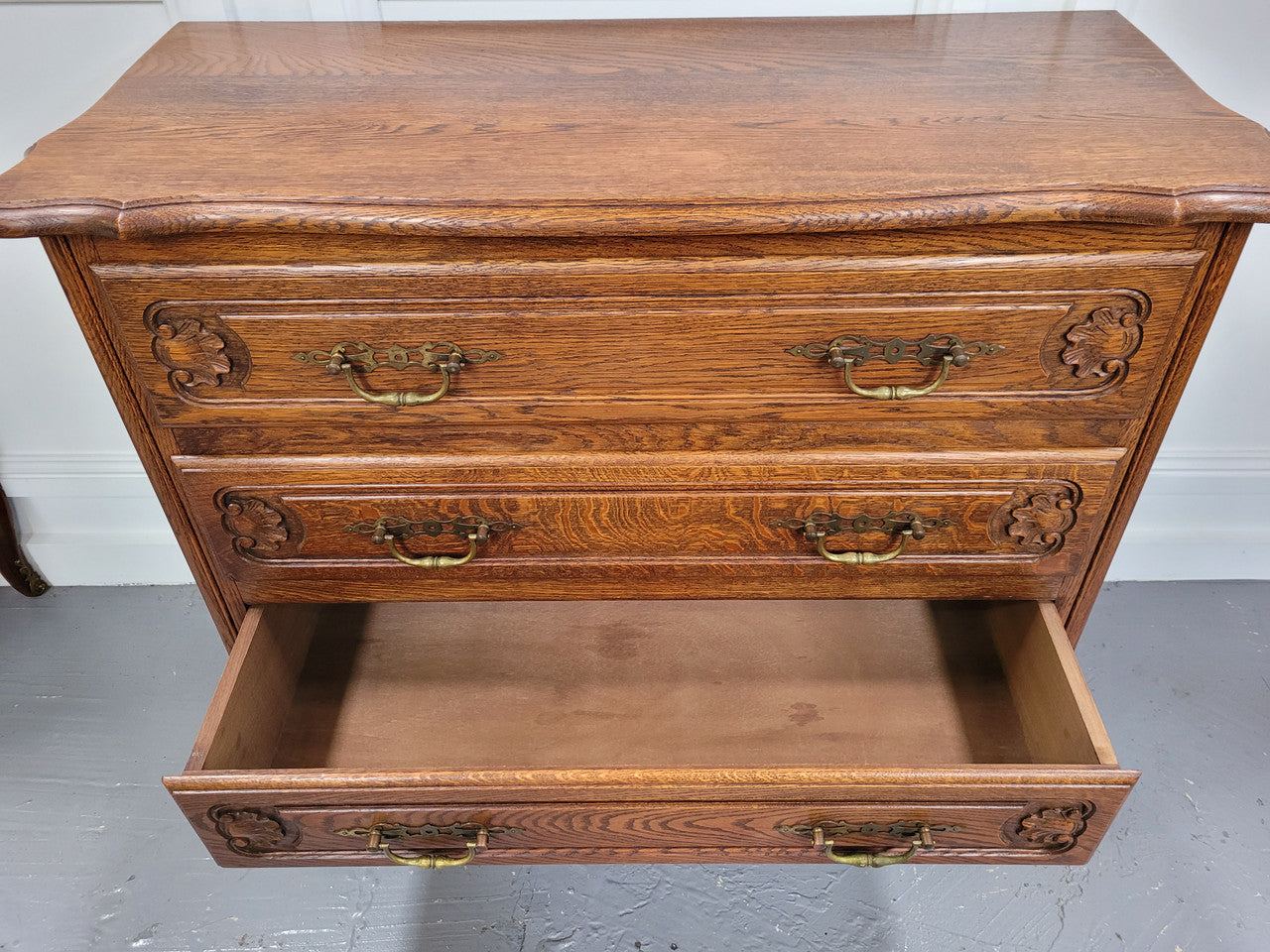 French Louis XV style Oak three drawer chest with wooden top. It has been sourced from France and is in good original detailed condition.