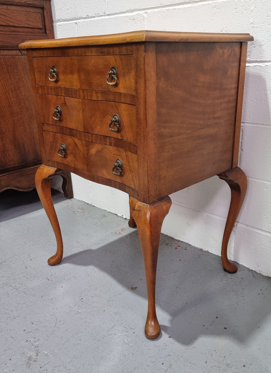 Antique Queen Anne style figured Walnut Bedside cabinet with 3 drawers. It is in good original detailed condition.