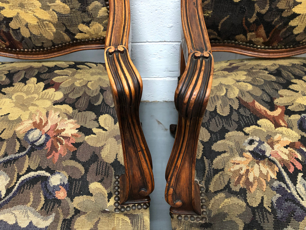 Pair of 19th Century French walnut tapestry covered arm chairs. They are in good original condition. Circa 1890.