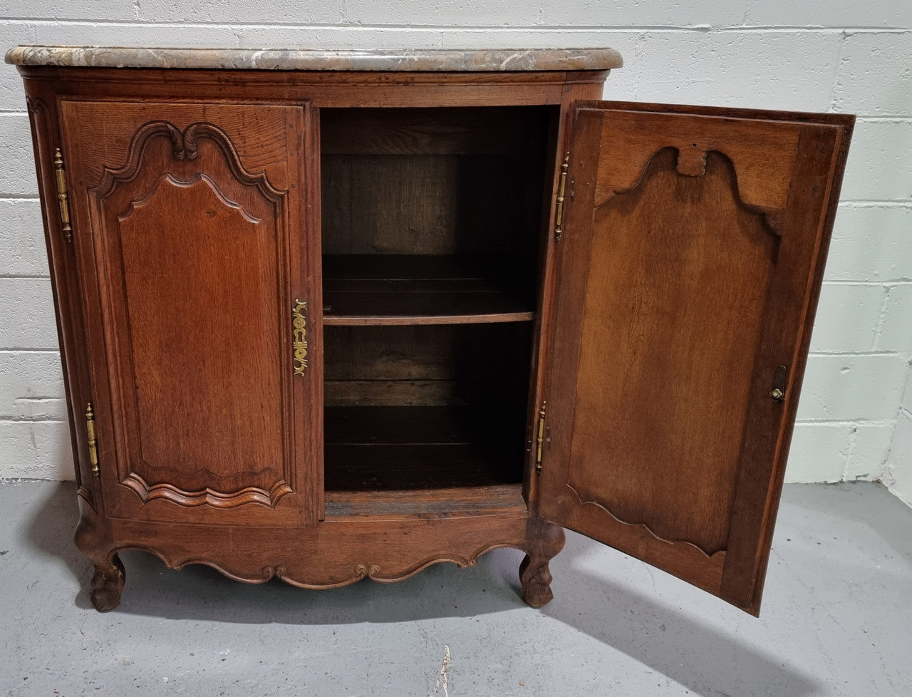 Rare 19th Century French Oak and marble top oval buffet / cabinet. Stunning thick marble top and decorative handles. In good original detailed condition.