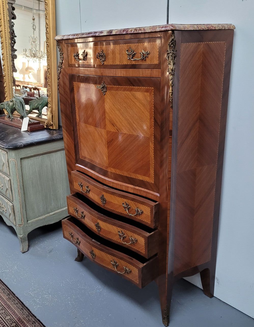 Walnut Louis XV style marble top abbattant with beautiful parquetry inlay and ormolu mounts. It has plenty of storage space with four large drawers and four smaller internal drawers. Beautiful drop down desk with a leather insert. In very good original detailed condition.