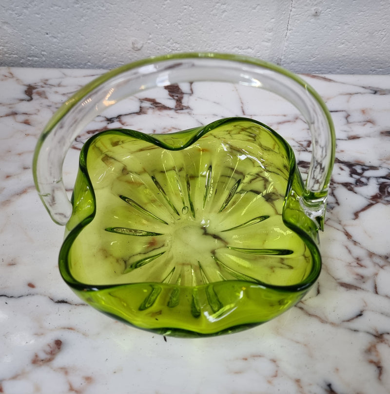 Delightful art glass vintage basket. Green glass bowl and clear handle.