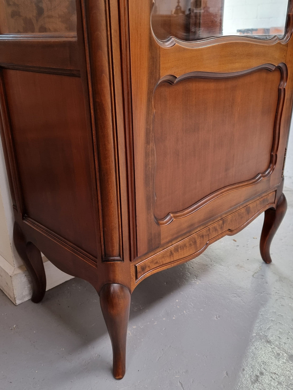 Petite French Louis XV style Walnut display cabinet with two glass shelves that can be adjusted and added storage at the bottom . In very good original detailed condition.
