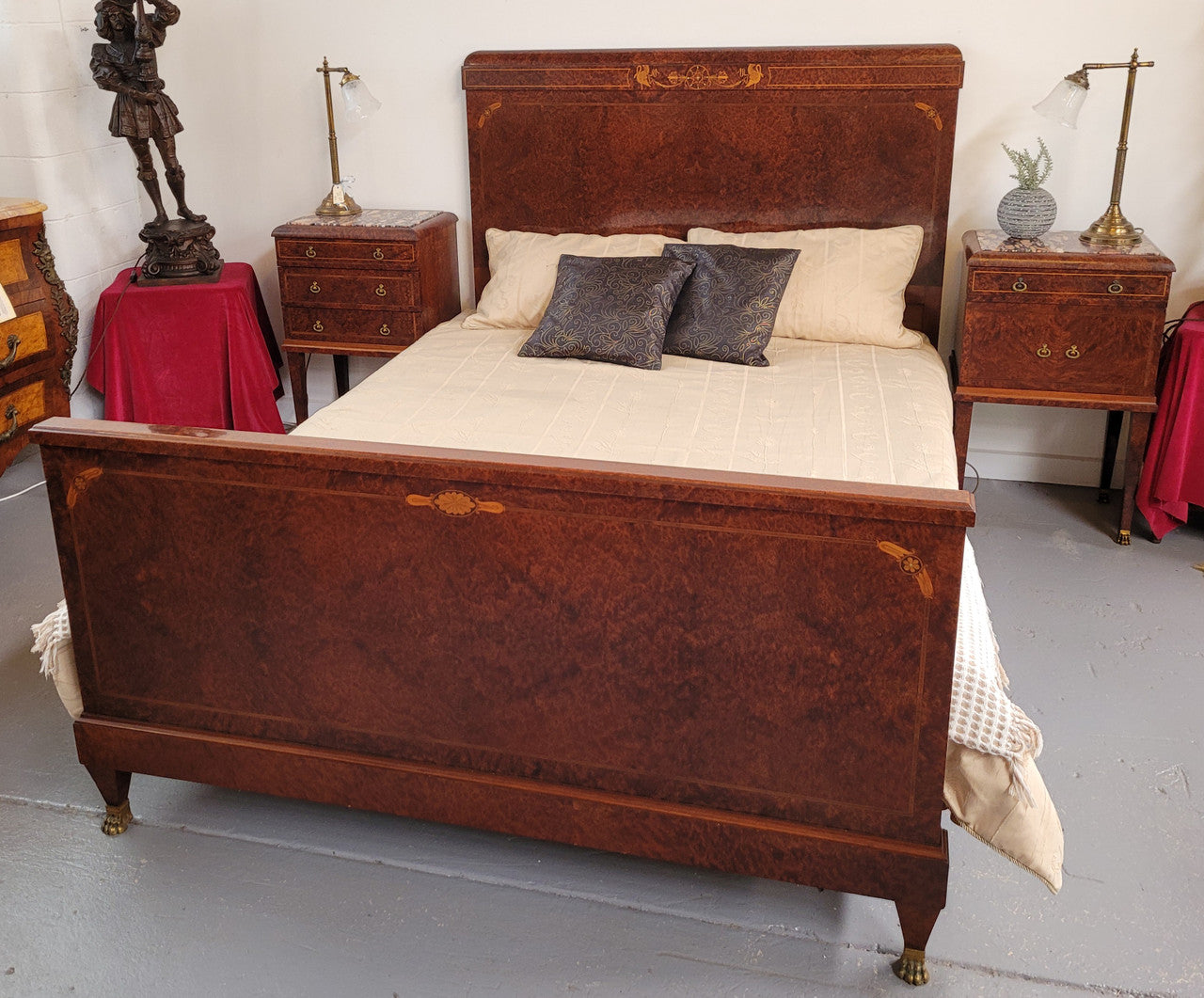 French Art Deco bedroom suite consisting of queen size bed in Amboyna wood and featuring pretty inlay. It comes with a matching pair of bedsides. It is a very stylish and high quality suite. It has been sourced from France and is in good original detailed condition.