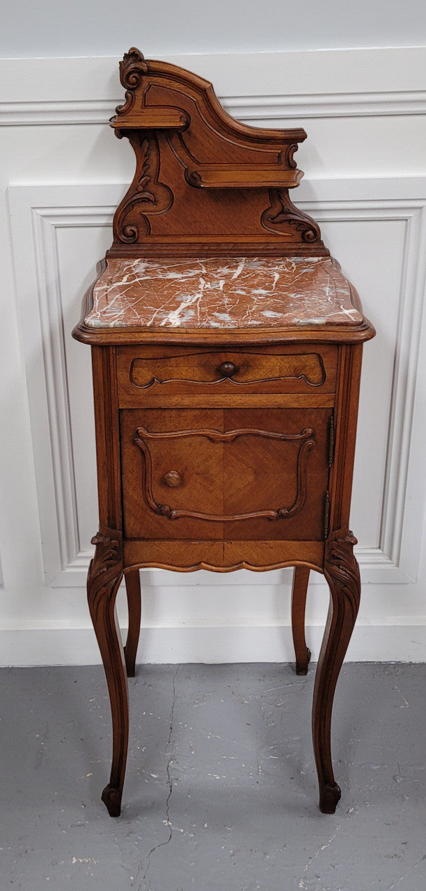 French Louis XV style Walnut single bedside cupboard with inset marble top. It has been sourced from France and is in good original detailed condition.