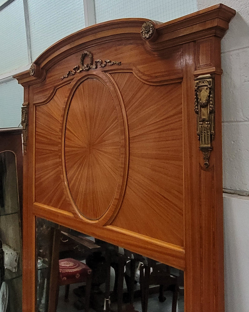 Stunning long Louis XV style satinwood Trumeau mirror decorated with Bronze ormolu mounts. It has its original bevelled mirror and it in good detailed condition. It has been sourced from France.