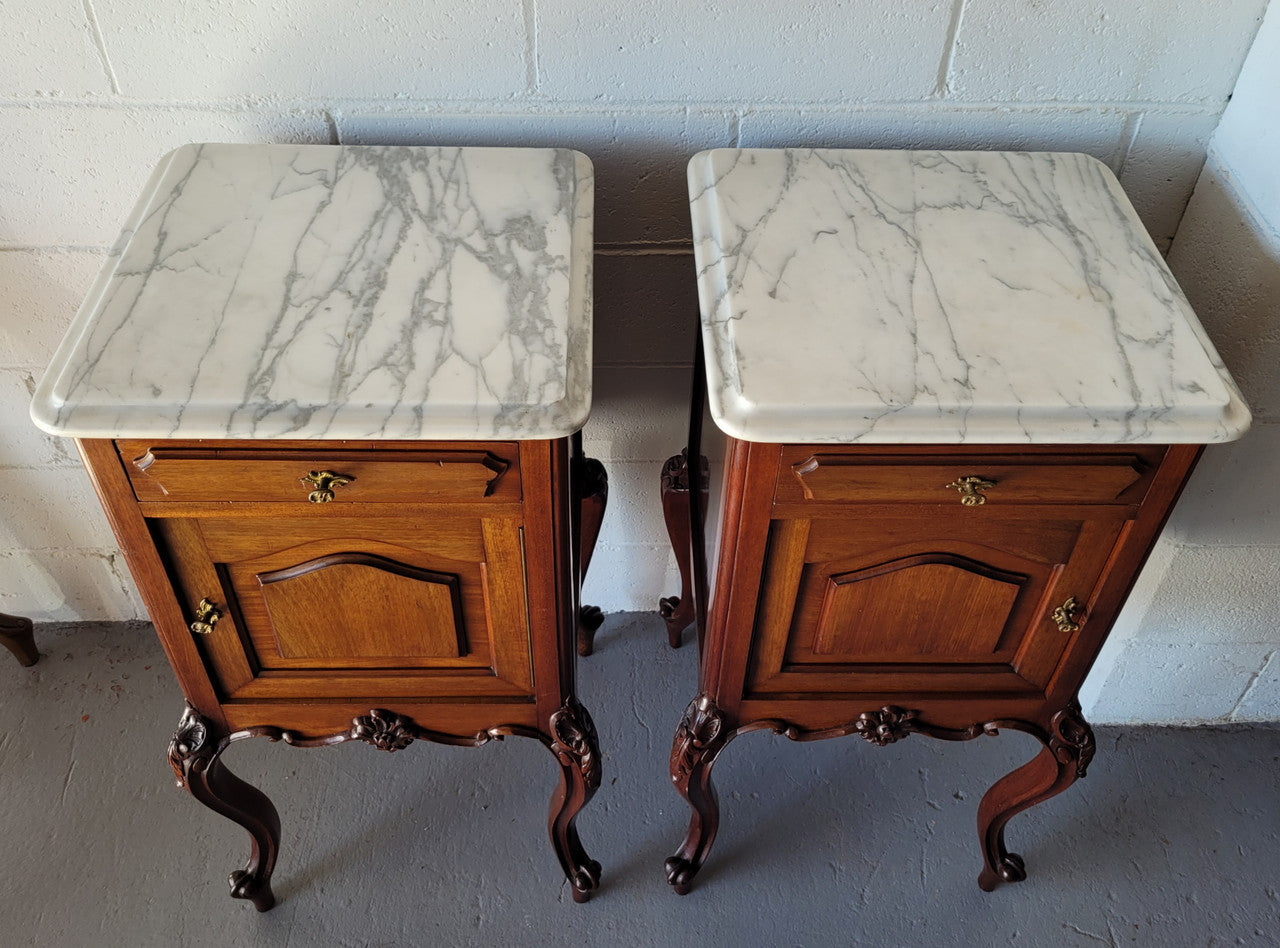 Pair of Louis XV style Walnut bedside cabinets marble top. Circa 1900 and in good original detailed condition.