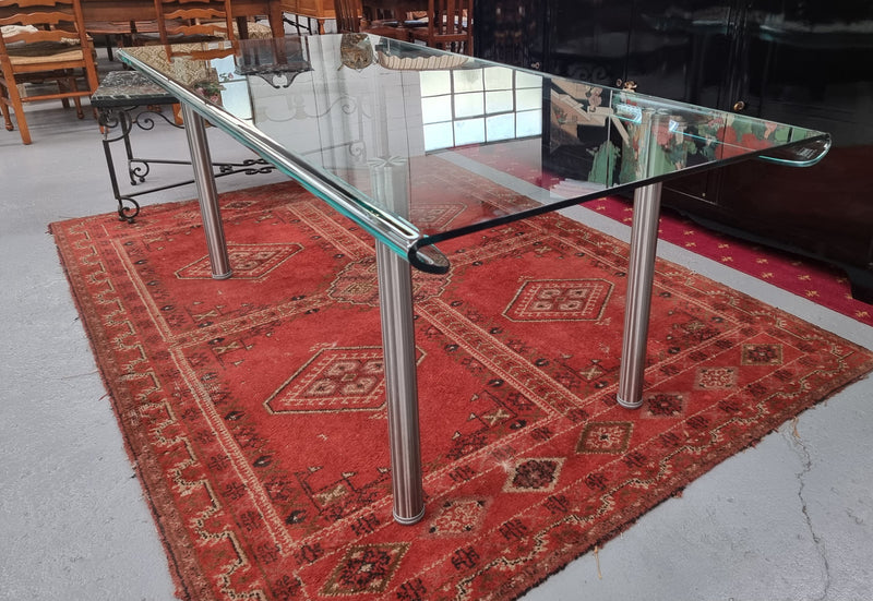 Striking and distinctive Vintage FIAM Italia Designer curved edge glass desk. FIAM was founded in 1973 by Vittorio Livio and has become synonymous with glass culture in Italy and the World. FIAM is still manufacturing today, in collaboration with various Designers, and has won numerous awards and is represented in various international museums. 
Condition: Evidence of use with minor scratches to the surface and a small chip that has been repaired. Overall, in very good condition with one repaired chip to t