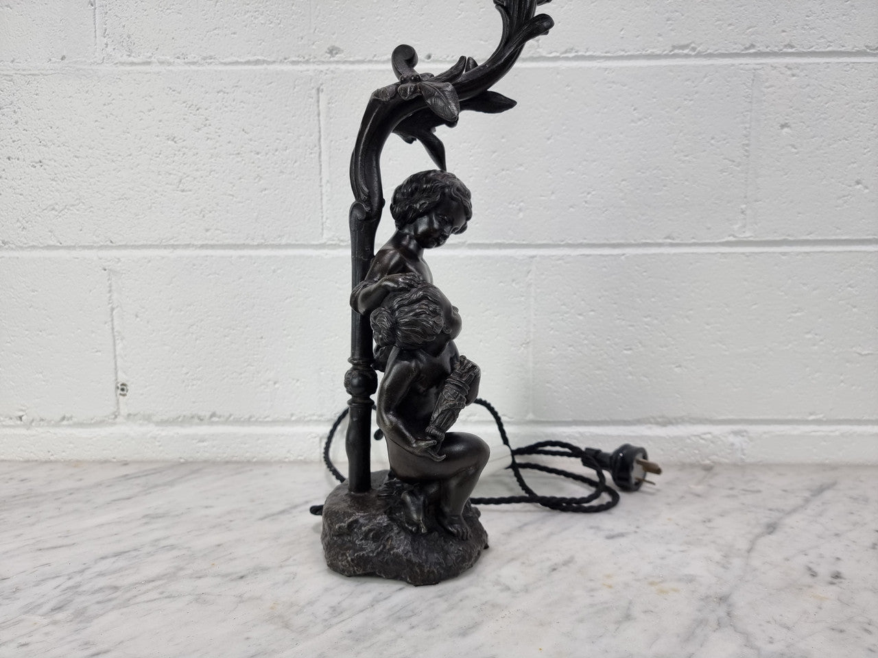 Antique French bronzed metal lamp with cherub's. in very good working original detailed condition.