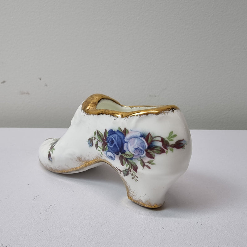 A lovely pair of Royal Albert China shoes in good original condition. Stamped on the sole 'Moonlight Rose: Royal Albert Bone China, England ©1987.