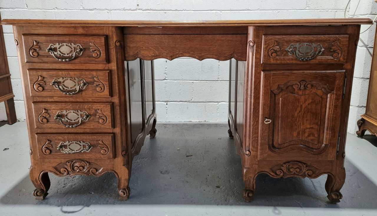 Beautifully carved french oak, faux partners desk with a lovely parquetry top and 6 drawers and 1 cupboard . In good original condition.