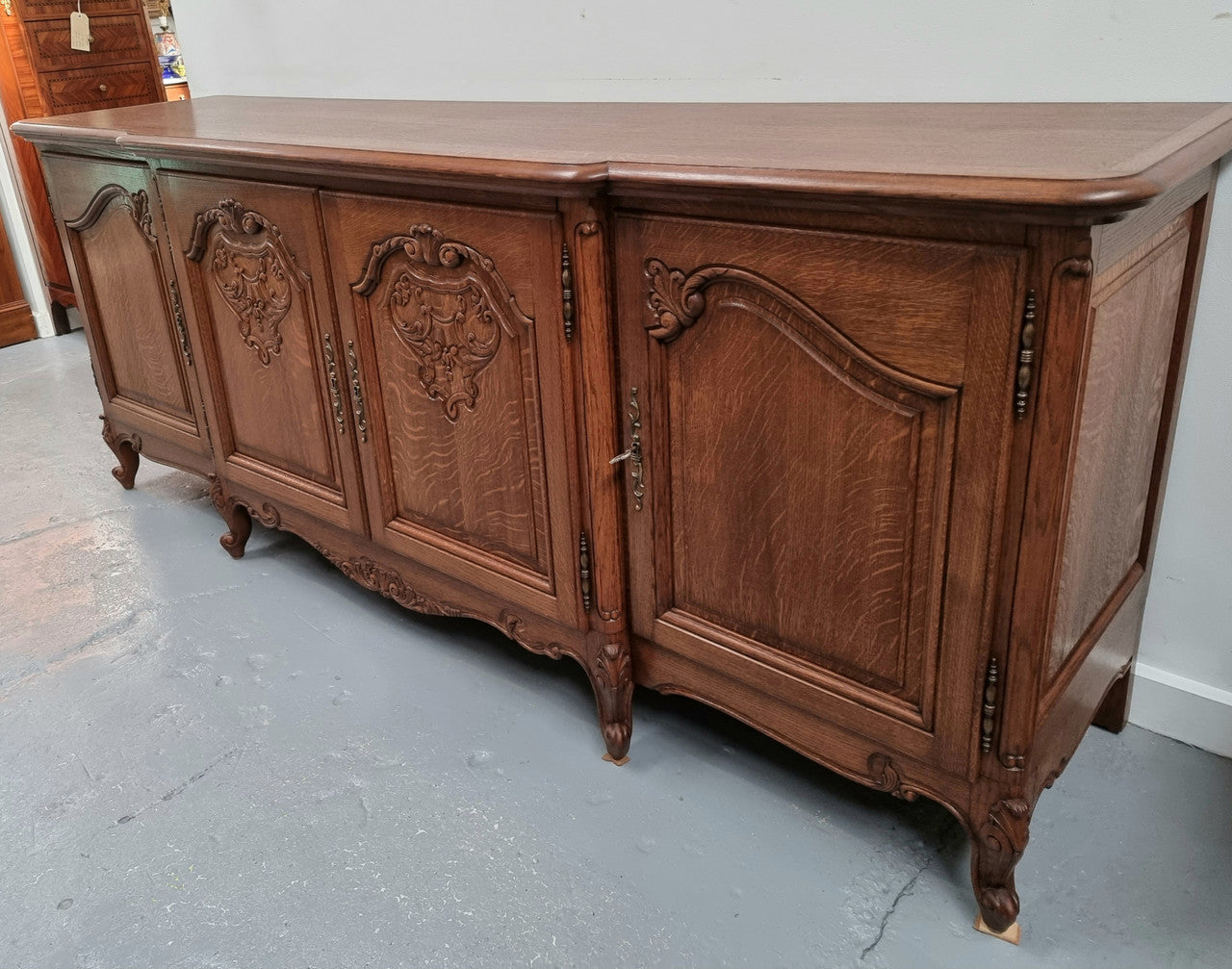 French oak large, beautifully carved four door sideboard with lockable doors and plenty of room for storage in good original condition.